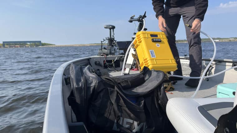 A person is working at the front of a boat.